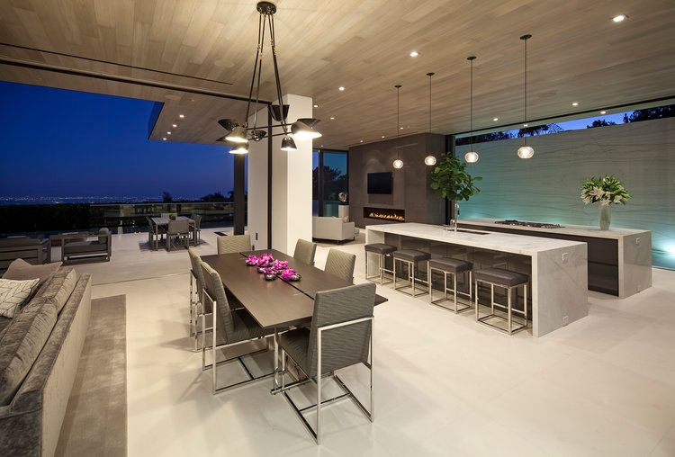 There is a dining room table and chairs in the middle of the room.