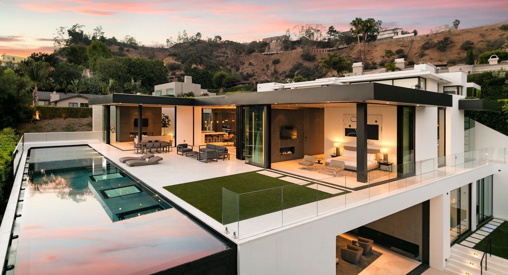 An aerial view of a modern house with a swimming pool.