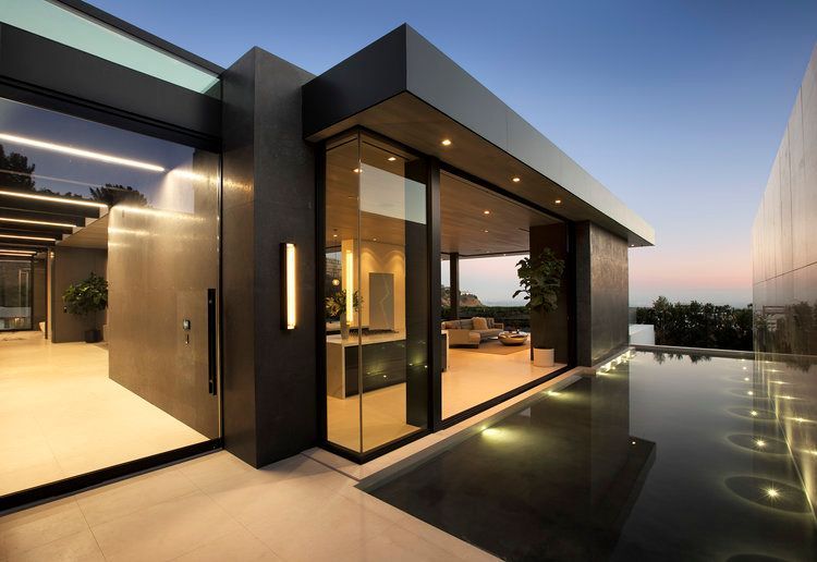 A modern house with a swimming pool in front of it