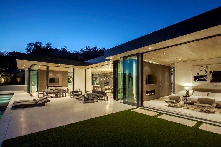 A modern house with a lot of windows and sliding glass doors.