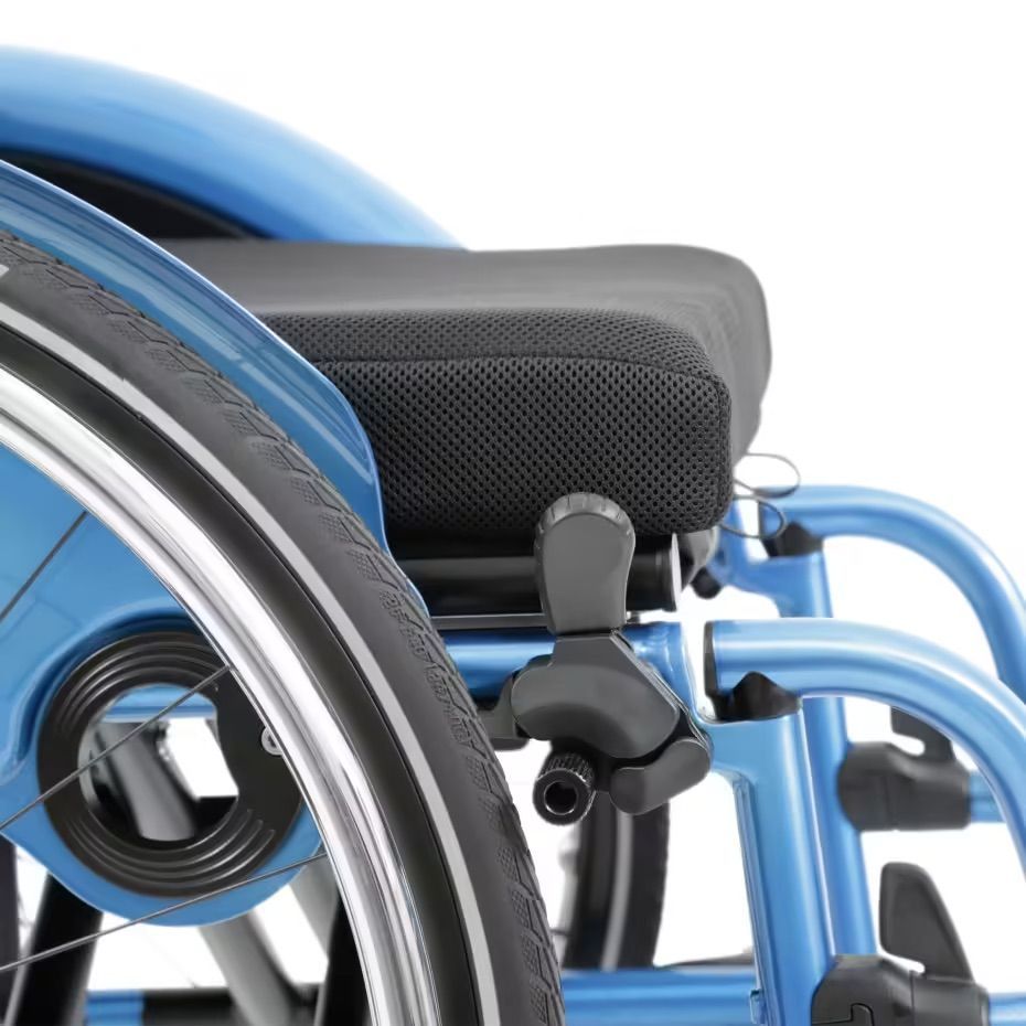 Close-up of a blue wheelchair with a black seat and a black tire.