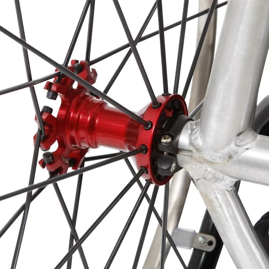 Red bicycle wheel hub with spokes, mounted on a silver frame.