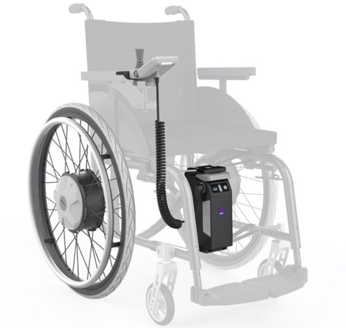 Electric wheelchair add-on. Black battery pack, motor on wheel, and control arm attached to the wheelchair frame.