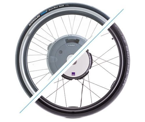 E-bike wheel with motor, partly obscured by a diagonal white line. Black and gray tire, silver rim, and spokes are visible.
