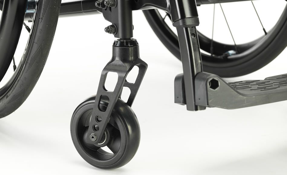 Black wheelchair front wheel, frame, and footrest on a white surface.