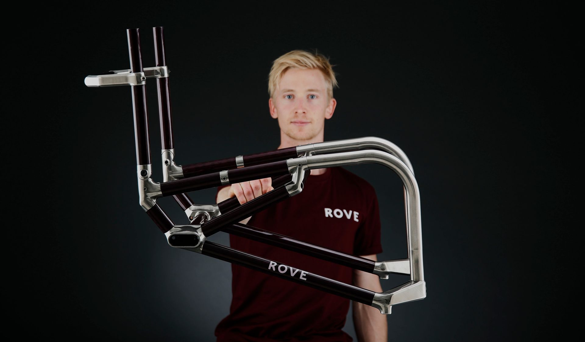 Man holding Rove Wheelchair frame with ROVE graphic on it