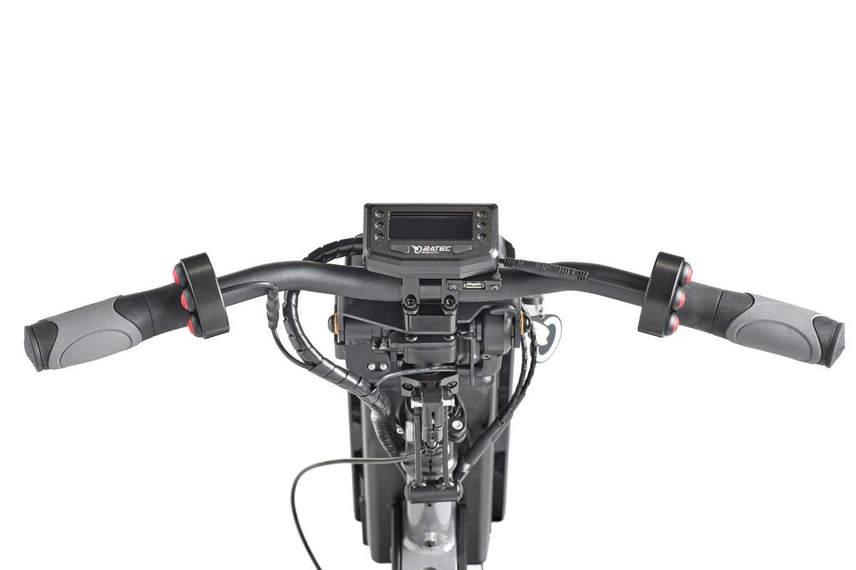 Handlebars of an electric scooter with a display, throttles, and control cables.