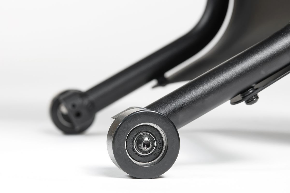 Black, wheeled bike stand, with close-up view of the wheels.