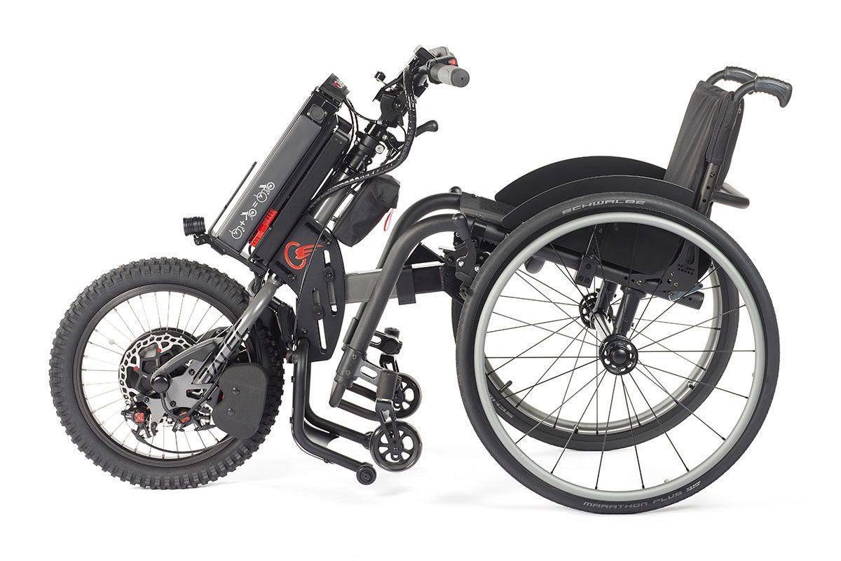Motorized wheelchair with large front wheel and battery, black and gray, side view.