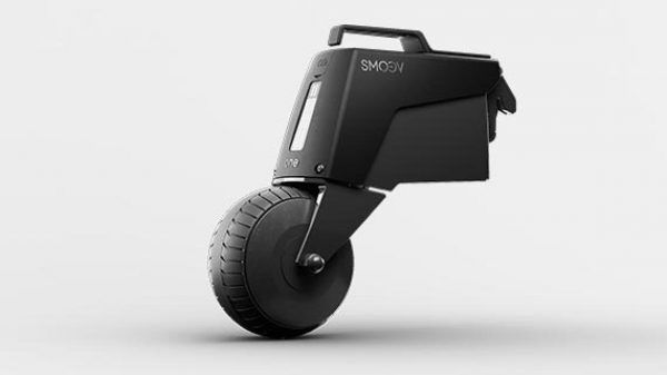 Black Shot-UX single-wheel electric scooter, with a handle, parked on a white surface.