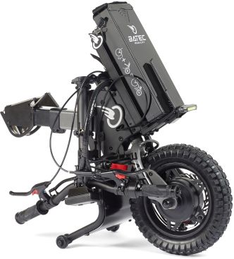 Black Batric electric wheelchair attachment, rear view. Large off-road tire, battery, control handle.
