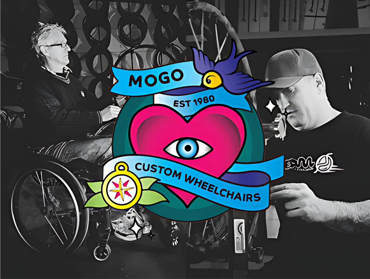 Wheelchair with a black seat and a black storage bag. The wheels are silver with green accents.