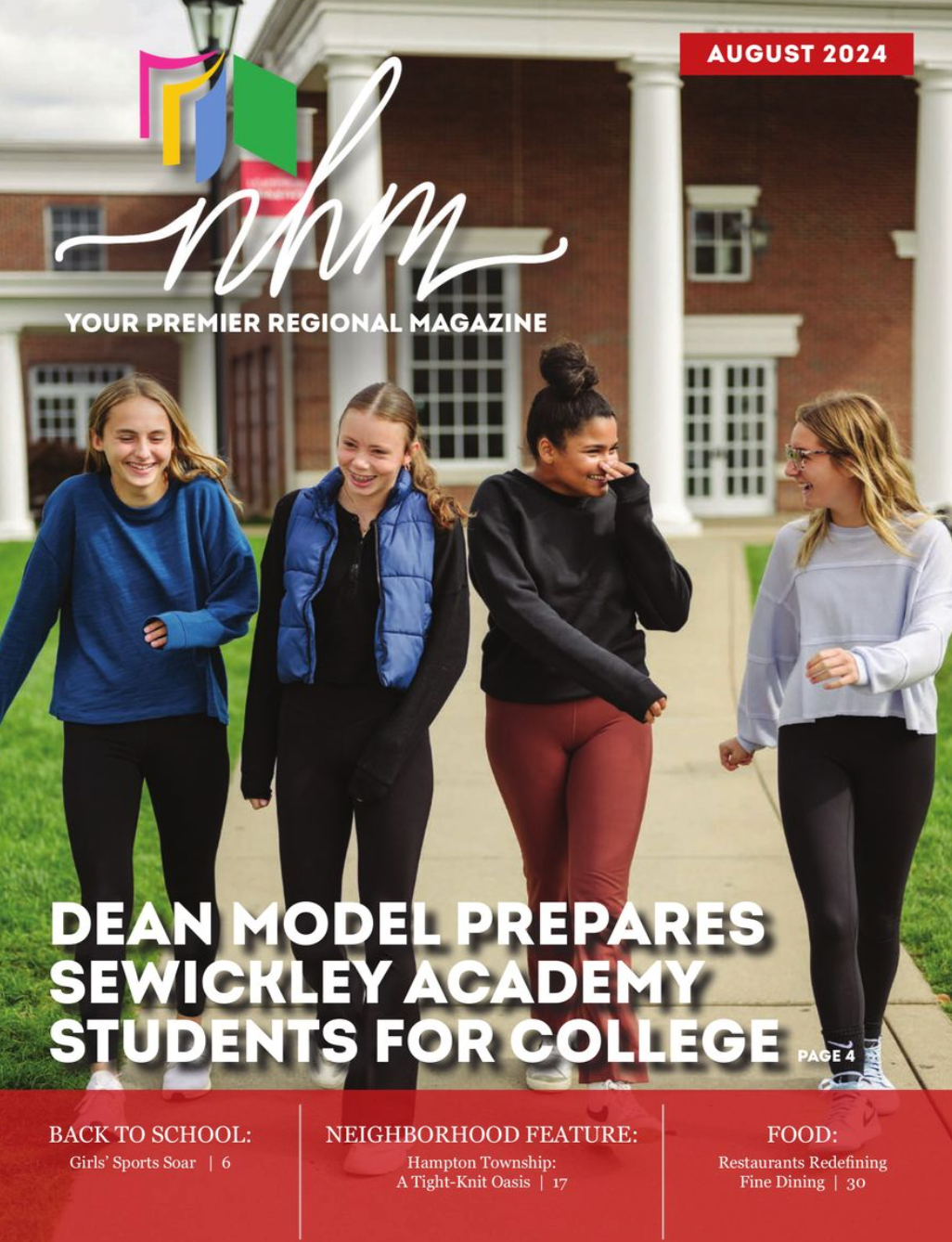 A group of young women are walking down a sidewalk in front of a building.