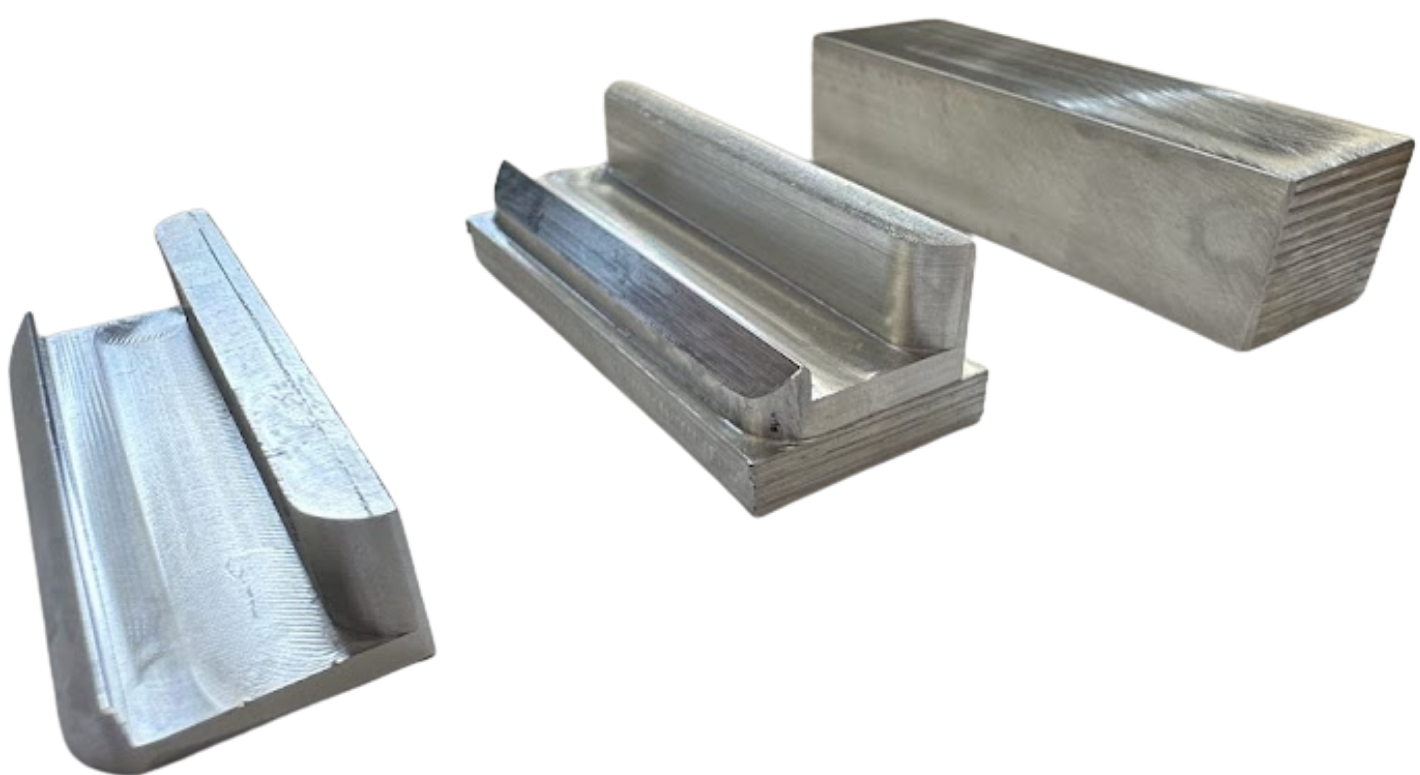 A bunch of metal rods are stacked on top of each other on a white surface.