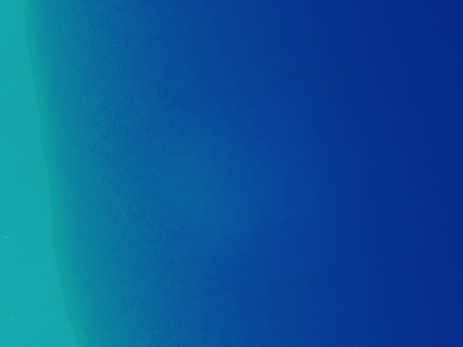 A blue background with a green gradient in the middle