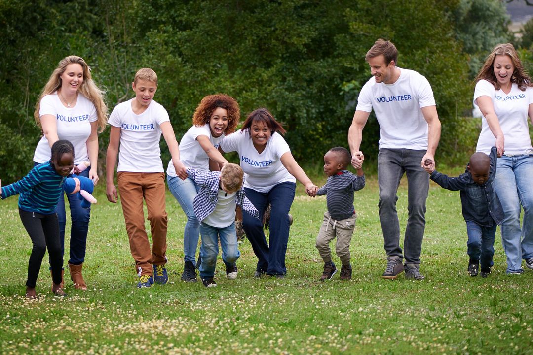 A group of people are holding hands in a park.