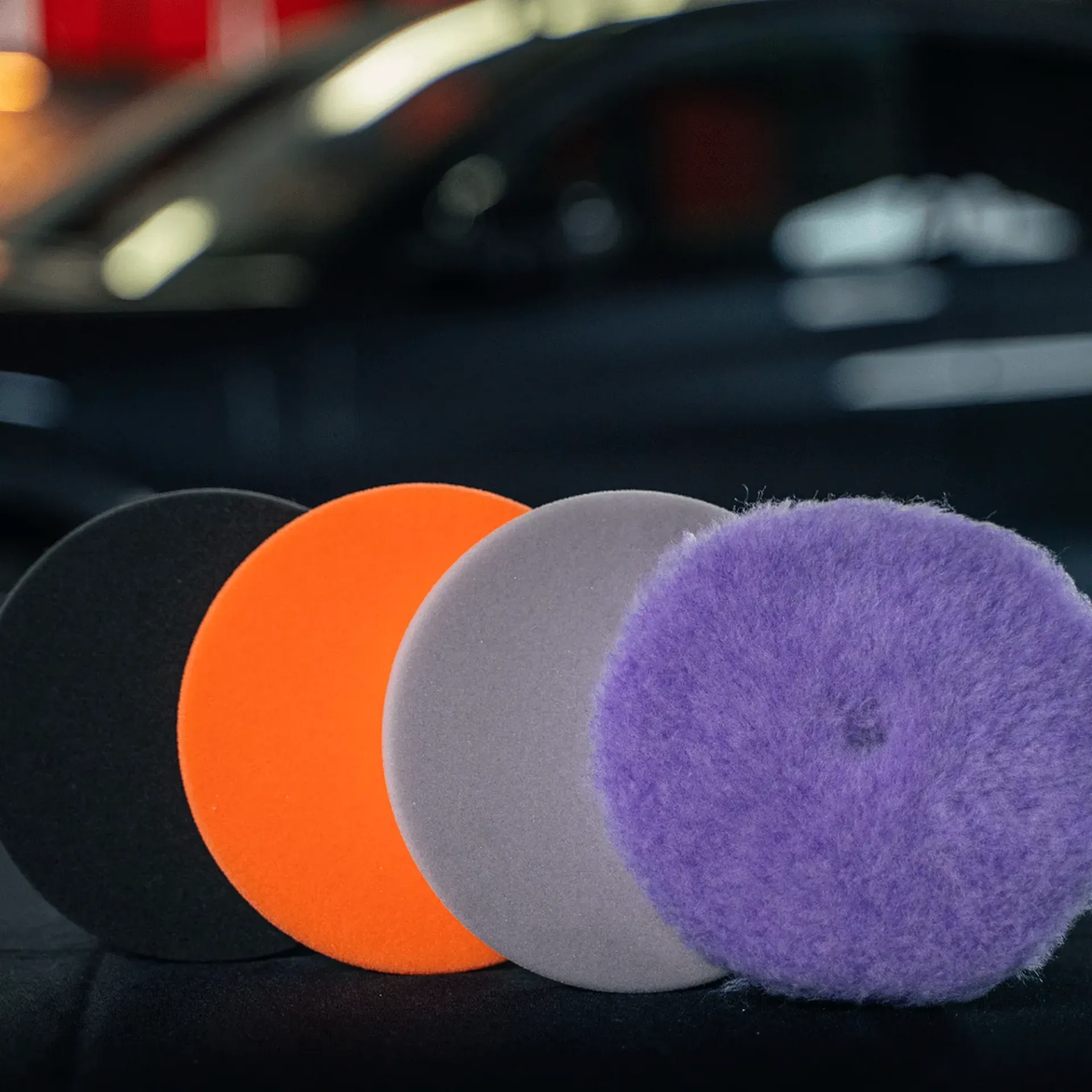 Bottles of various cleaning products in different colors, including blue, green, are grouped together on a white background.