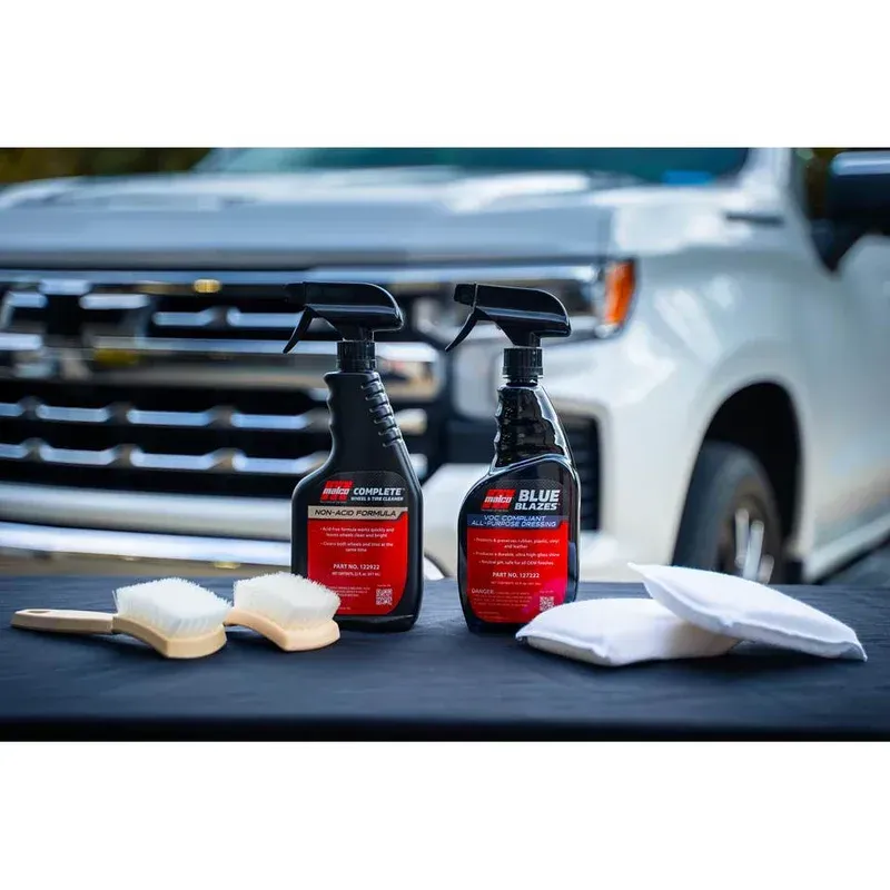 Shelves stocked with colorful oil containers, bags, and tools inside a store.