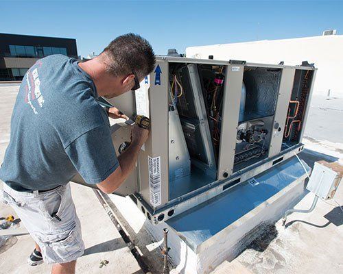 Experience — Man Repairing The Air Conditioner in Loveland, CO