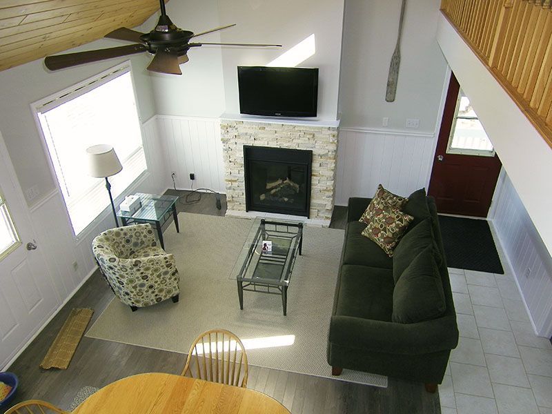 A living room with a fireplace and a flat screen tv