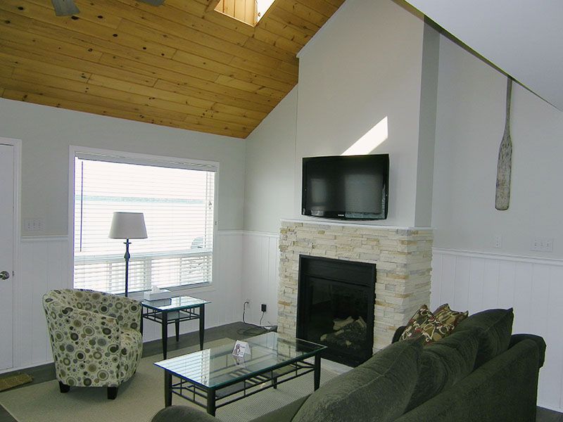 A living room with a fireplace and a flat screen tv