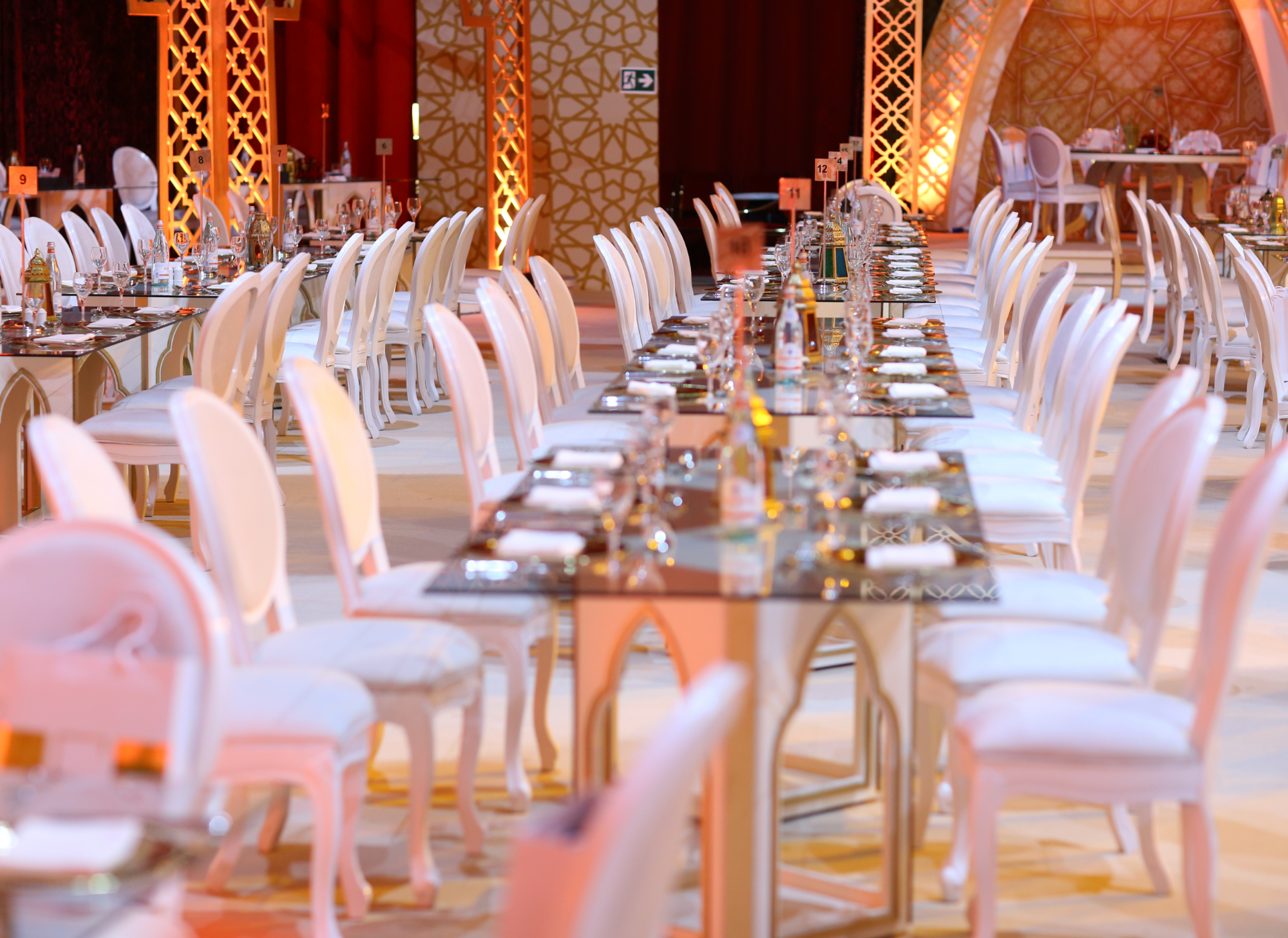 A large room with tables and chairs set up for a wedding reception.