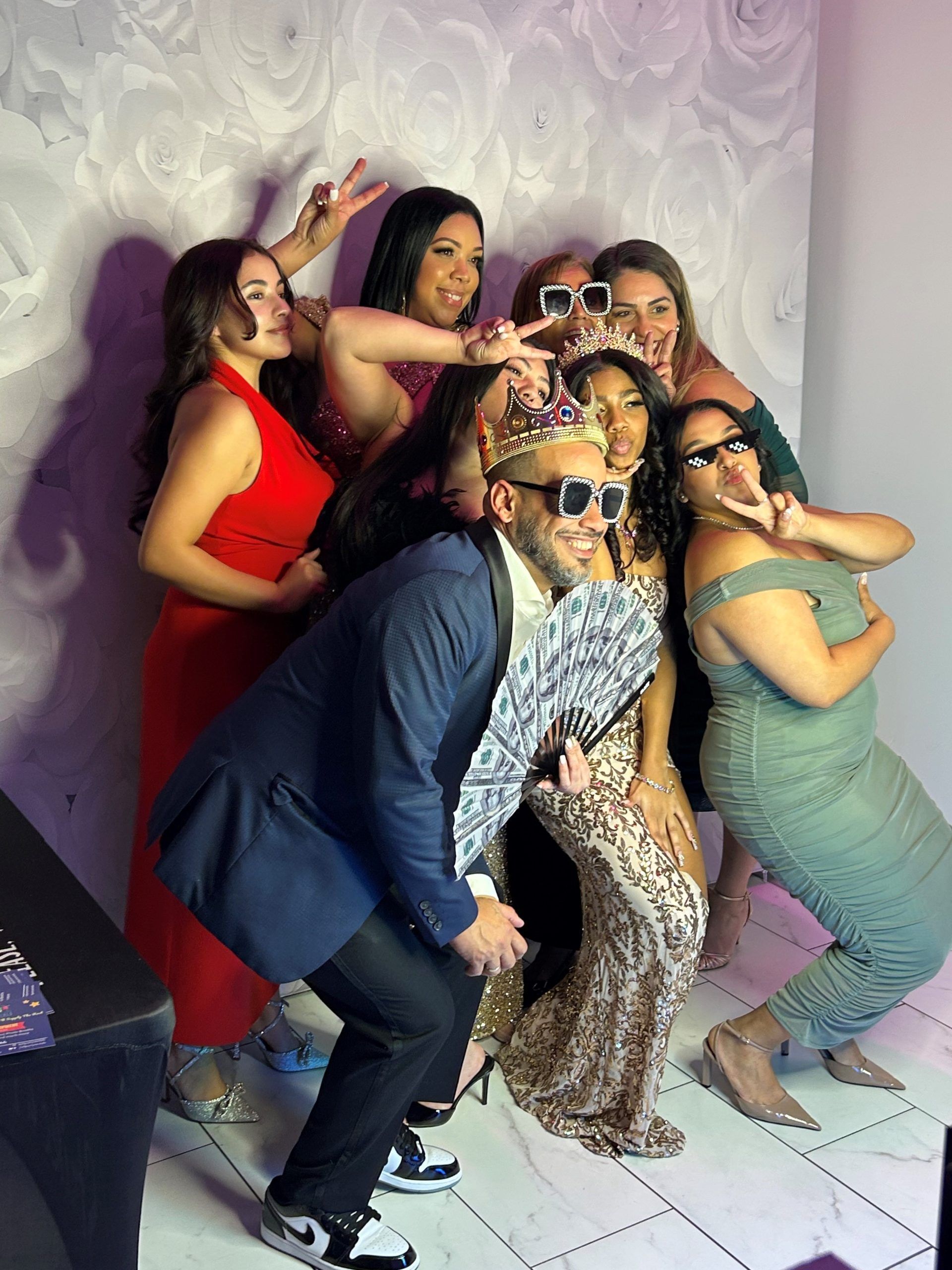 A group of people are posing for a picture in a photo booth.