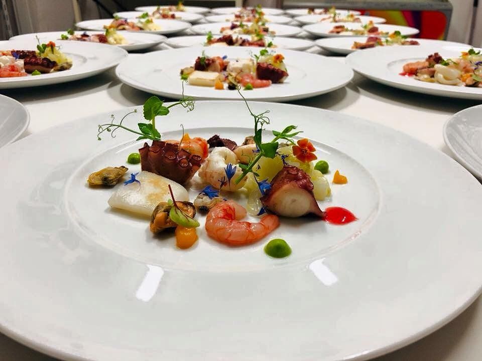A row of trays filled with different types of bread and pastries.