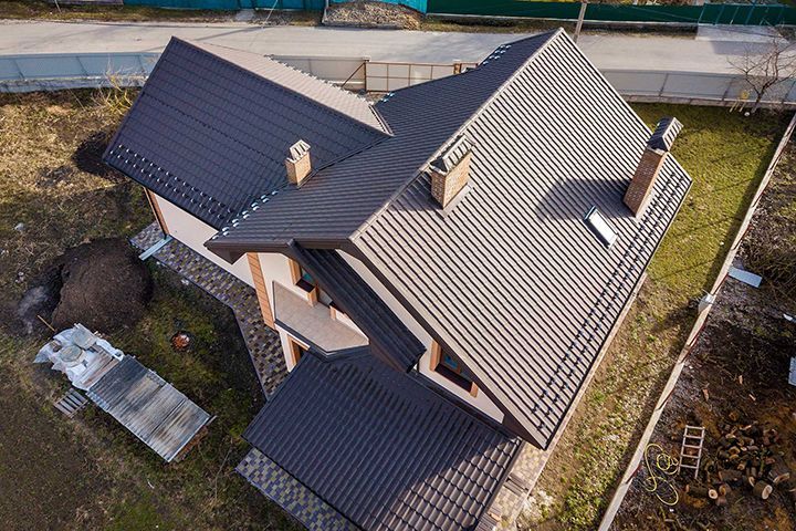 Aerial top view of building steep shingle roof