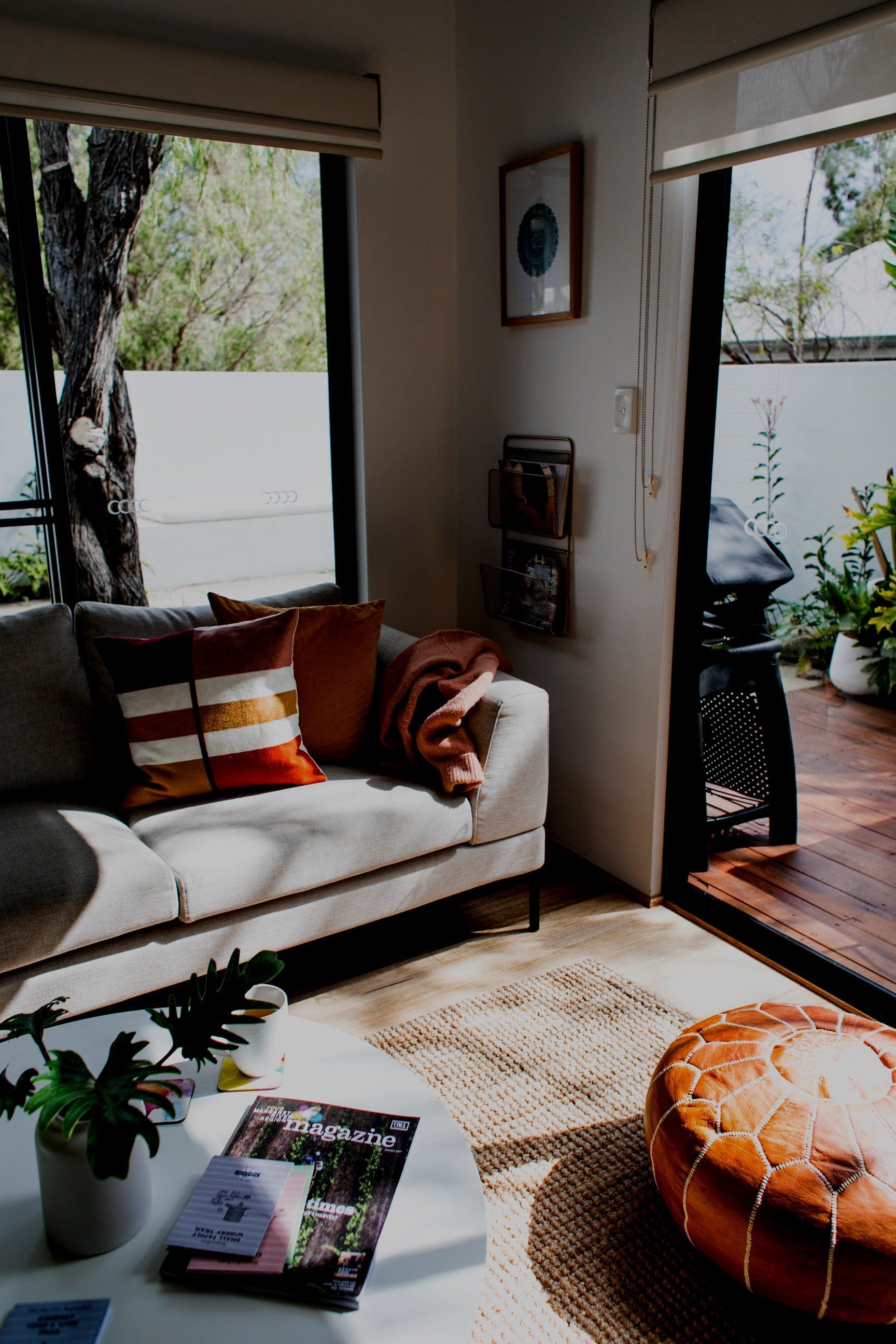 A living room with a couch , table , and ottoman.