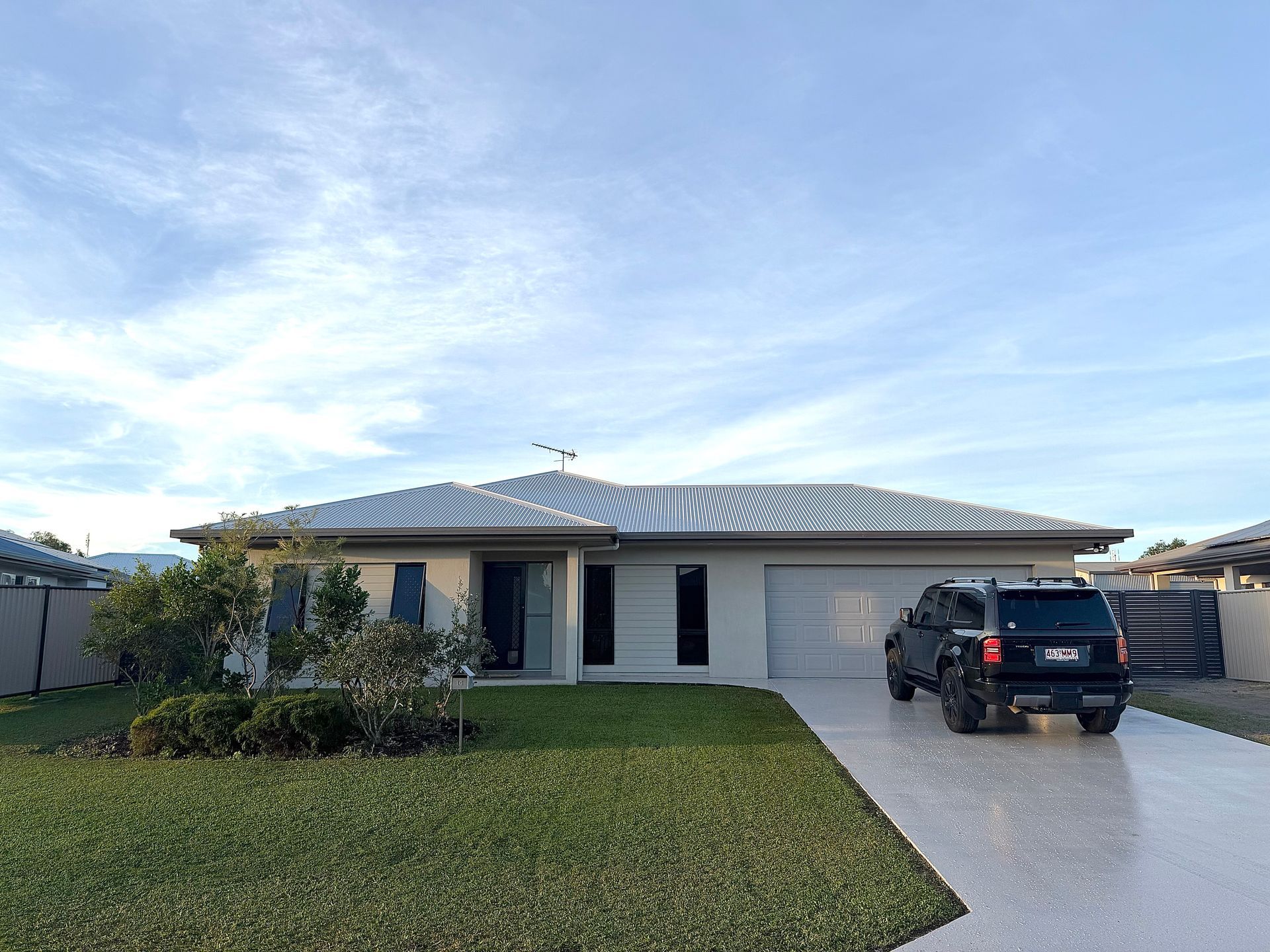 An empty garage with a new epoxy floor — All Grind & Coat in Cairns, QLD