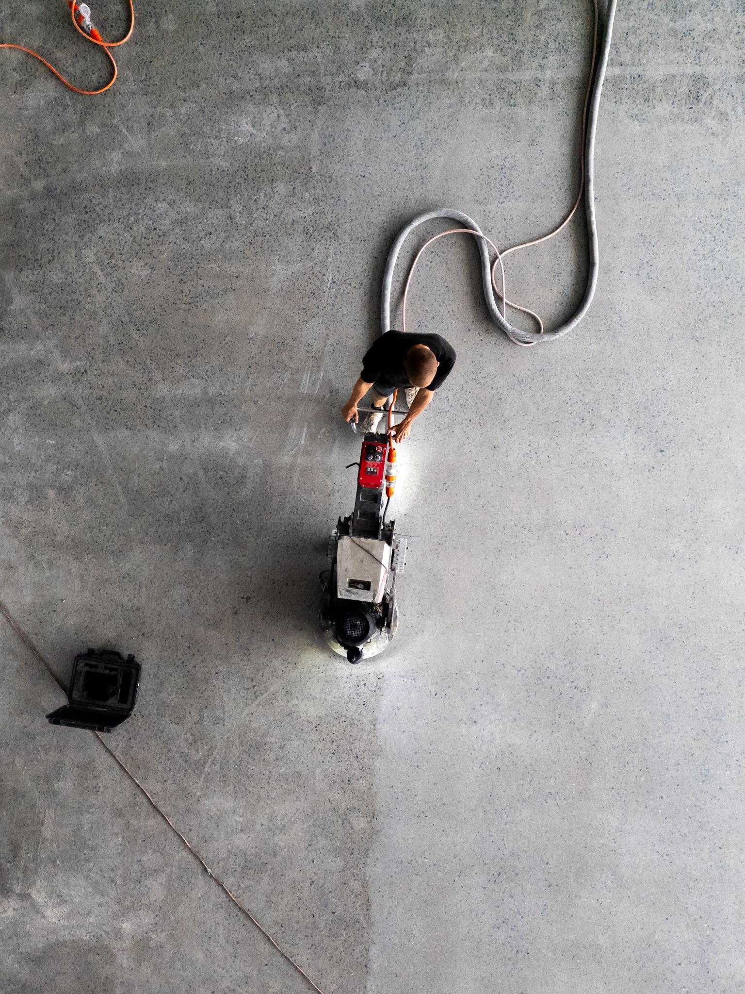 An empty garage with a new epoxy floor — All Grind & Coat in Cairns, QLD