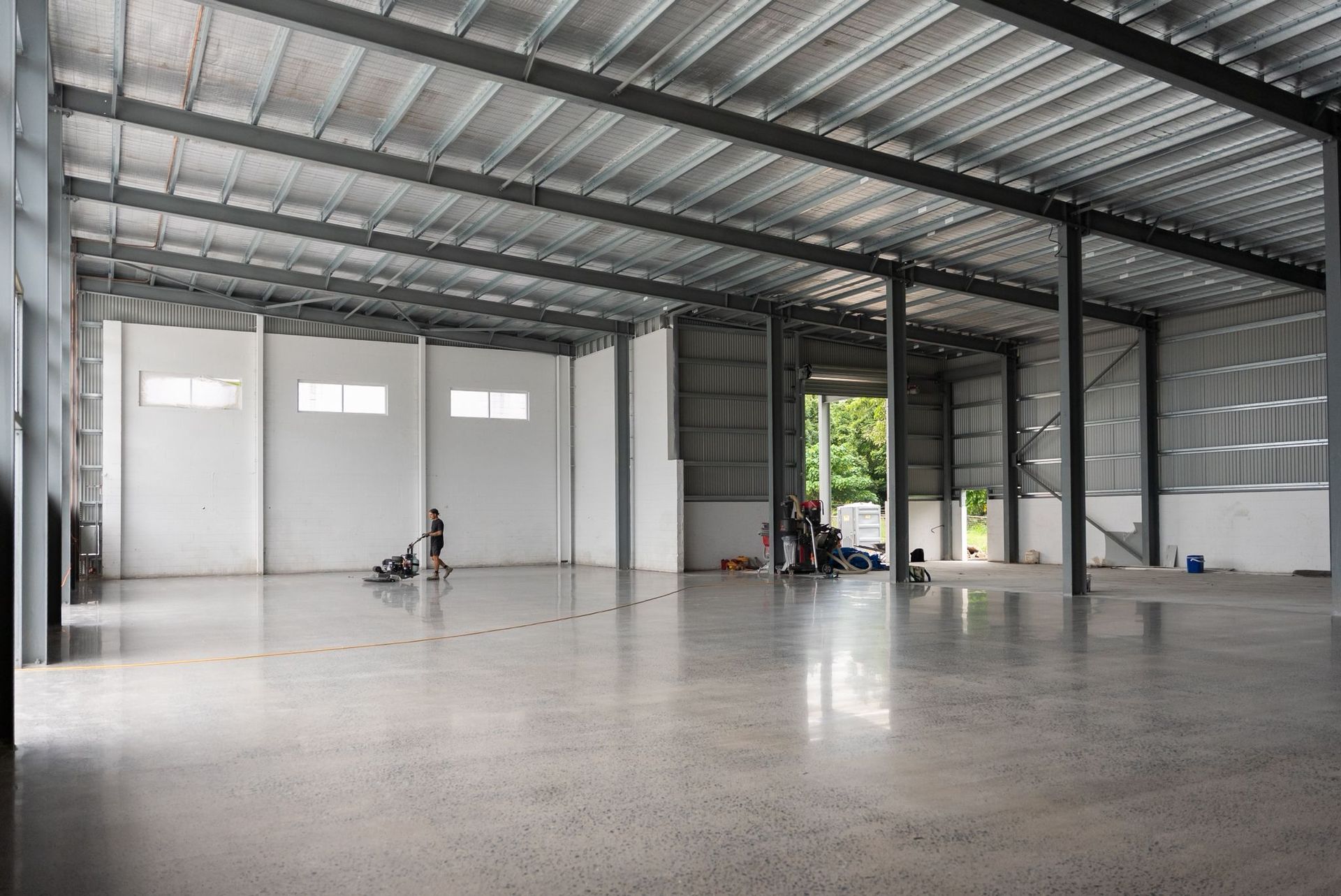 An empty garage with a new epoxy floor — All Grind & Coat in Cairns, QLD