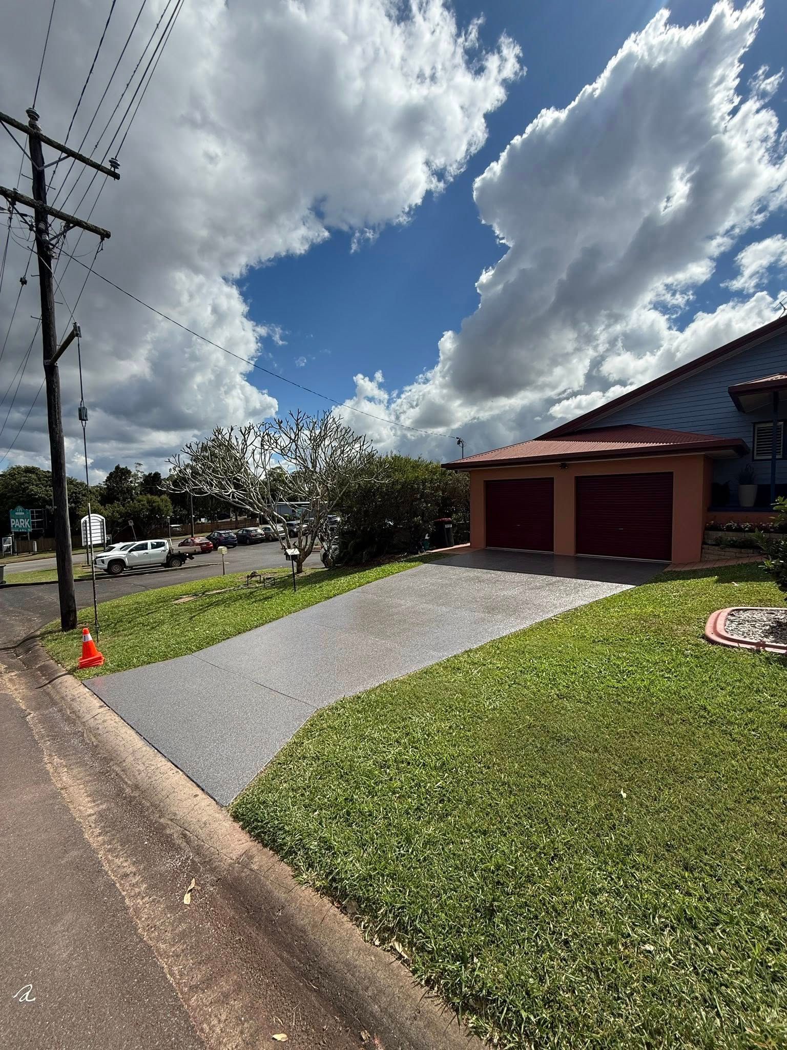 A Garage With A new Epoxy Floor Door Open — All Grind & Coat in Cairns, QLD