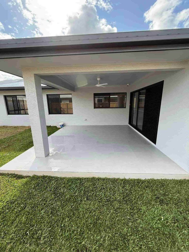 A Trailer With A Hose Attached To It Is Parked In Front Of A House — All Grind & Coat in Cairns, QLD