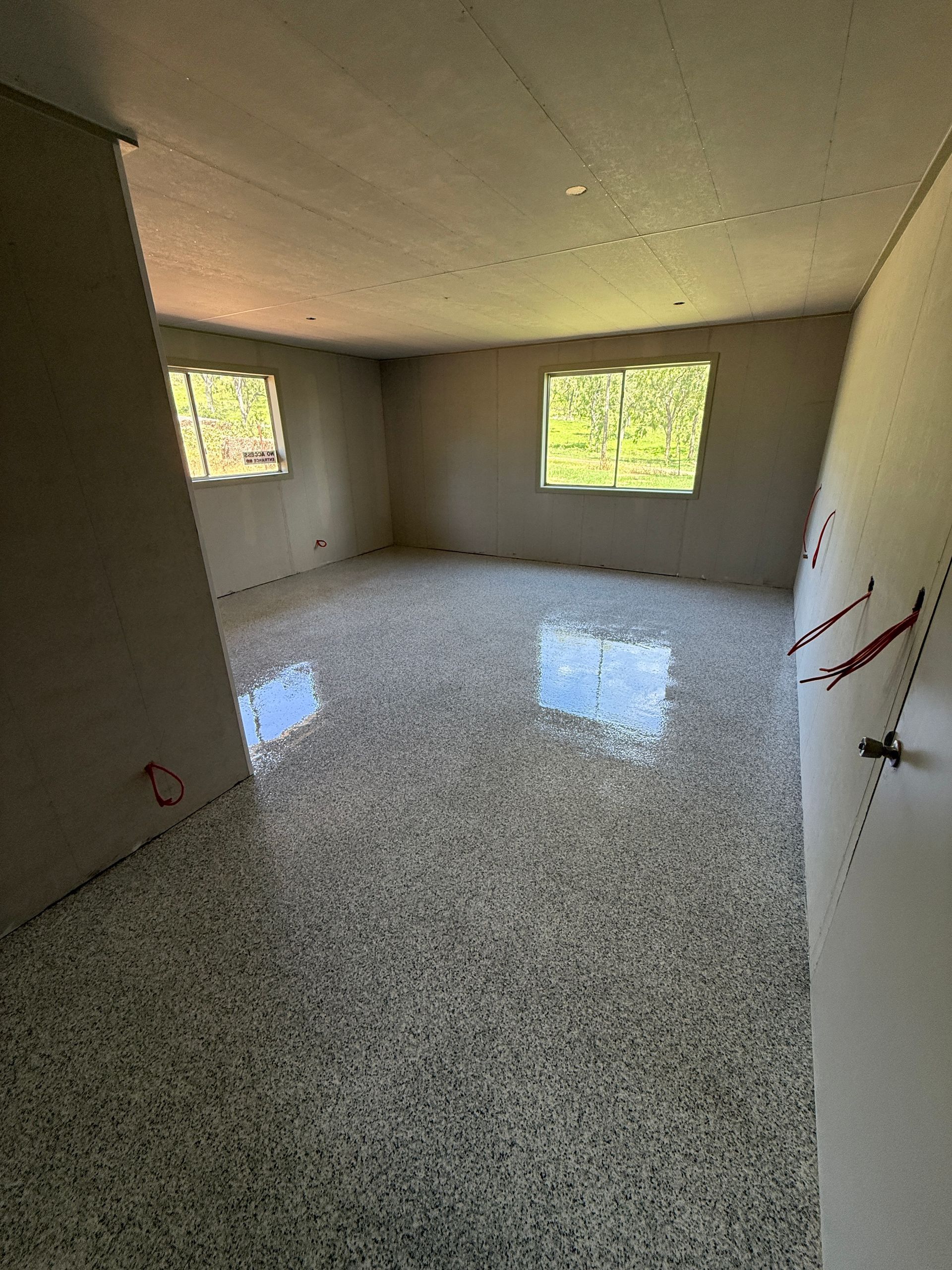 Room With Speckled Epoxy Floor, Drywall Walls — All Grind & Coat in Cairns, QLD