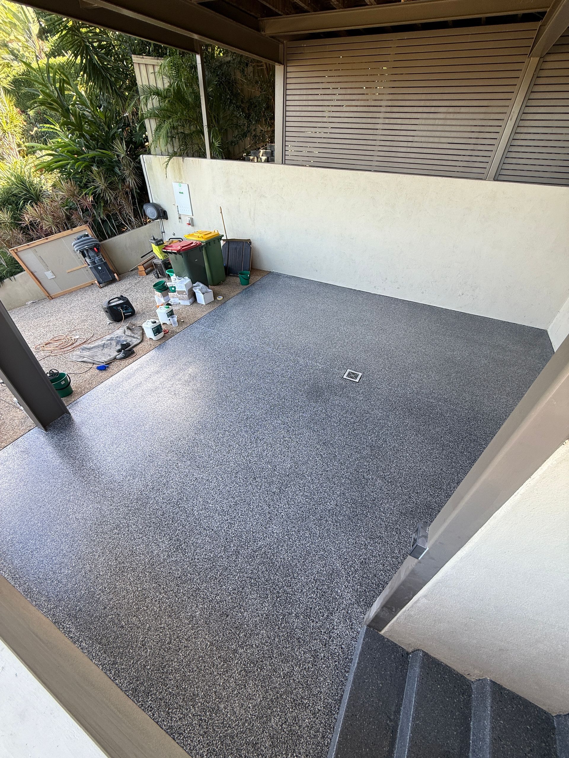 Patio With Gray Speckled Flooring, Beige Walls, And A Wooden Pergola — All Grind & Coat in Cairns, QLD