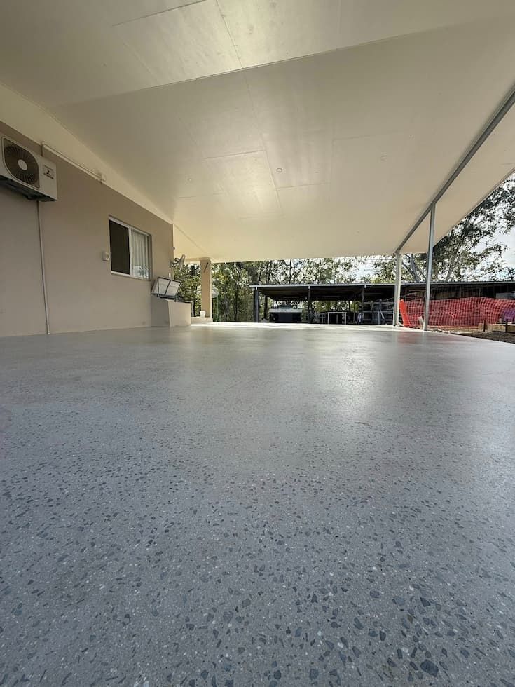 View of a Spacious, Covered Patio With a Polished Concrete Floor
