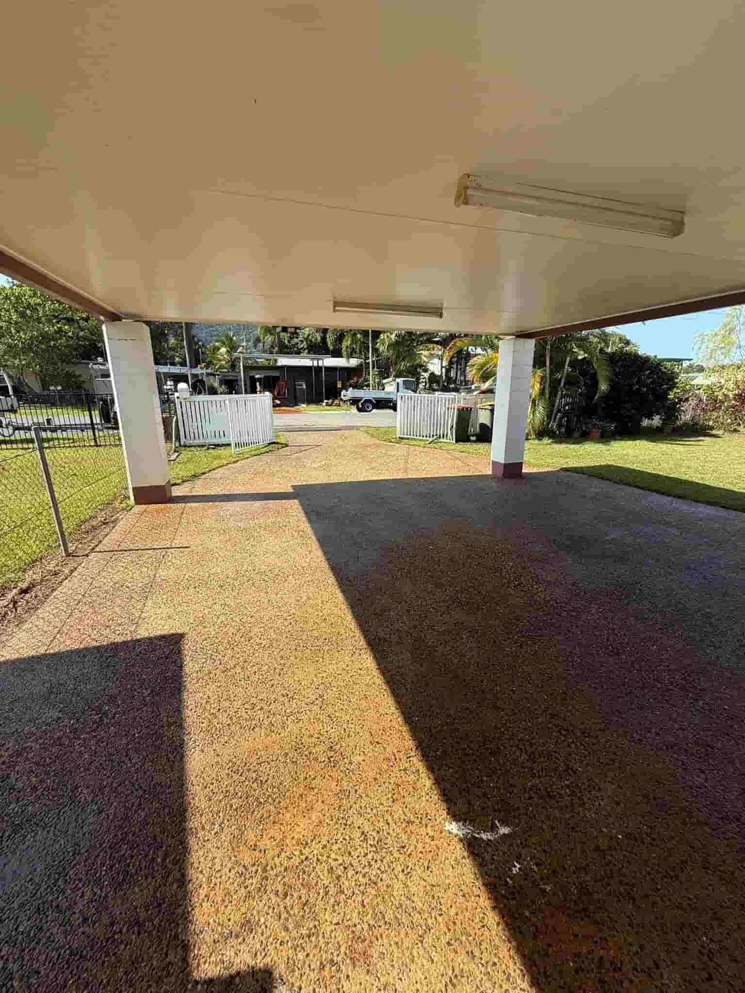 A carport with a covered walkway leading to a house — All Grind & Coat in Cairns, QLD