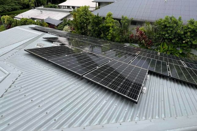 There Are Many Solar Panels On The Roof Of A House — All Grind & Coat in Cairns, QLD