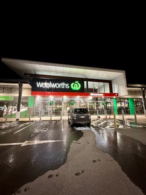 A Car Is Parked In Front Of A Woolworths Store — All Grind & Coat in Cairns, QLD