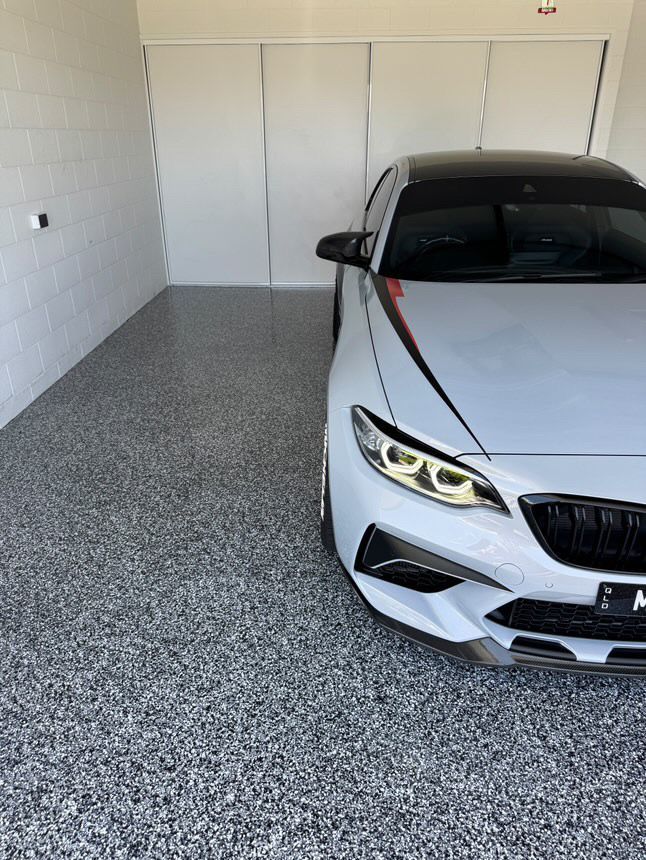 White Bmw Car Parked In A Garage With Speckled Gray Flooring And White Walls — All Grind & Coat in Cairns, QLD