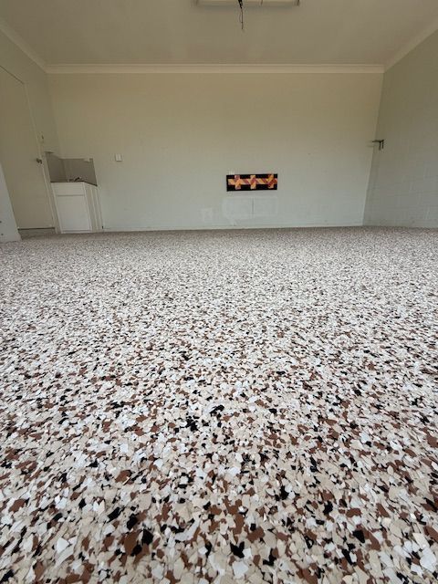 An Empty Room With A Carpeted Floor And White Walls — All Grind & Coat in Cairns, QLD