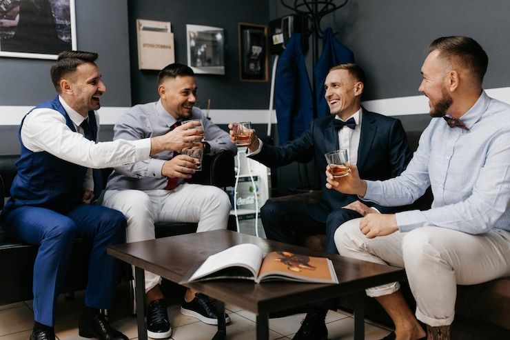 Wine barrels stacked in rows on metal racks in a cellar.