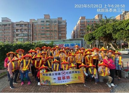 A group of people standing next to each other holding a sign with chinese writing on it.