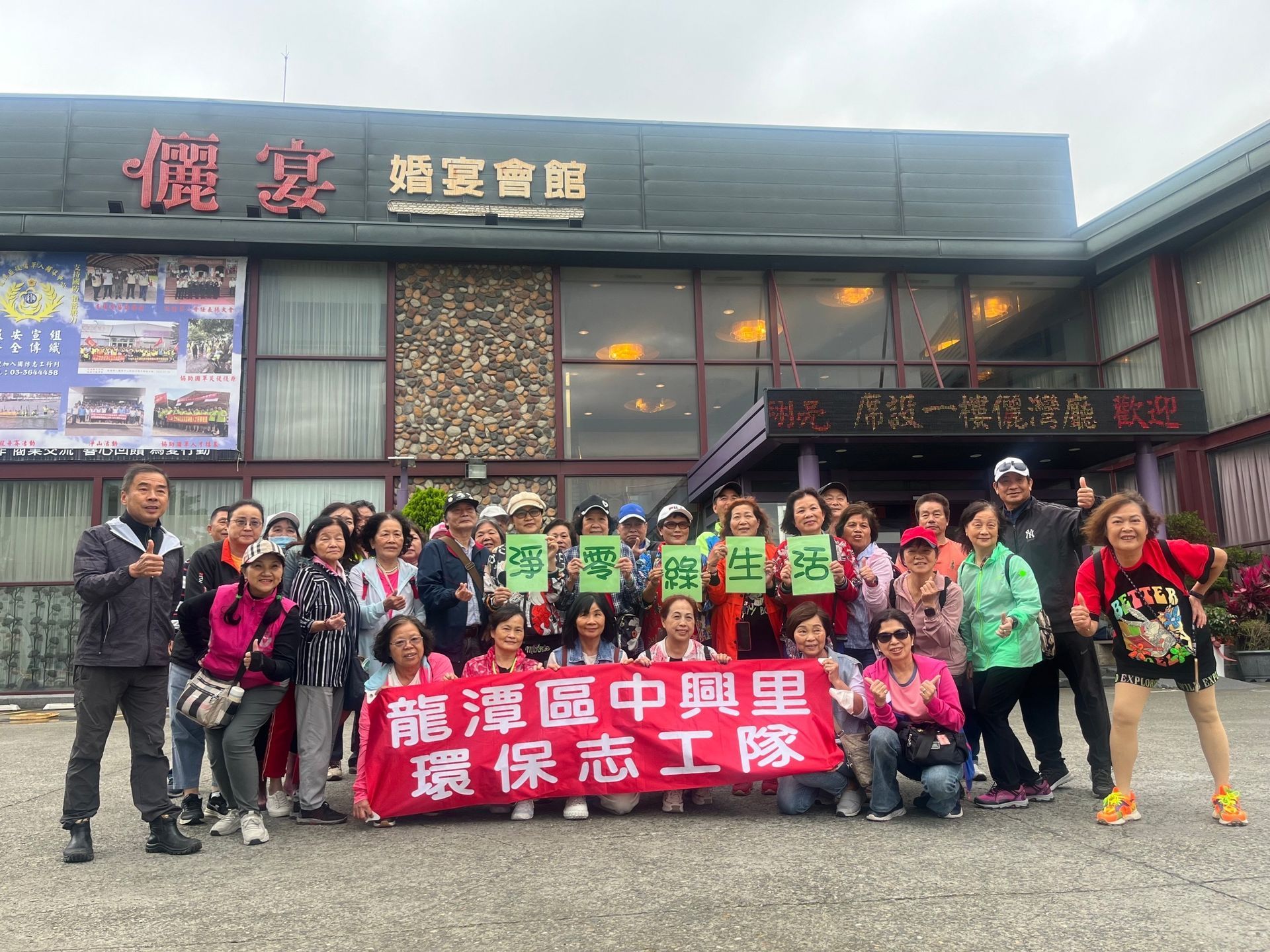 A group of women are posing for a picture on a tennis court.