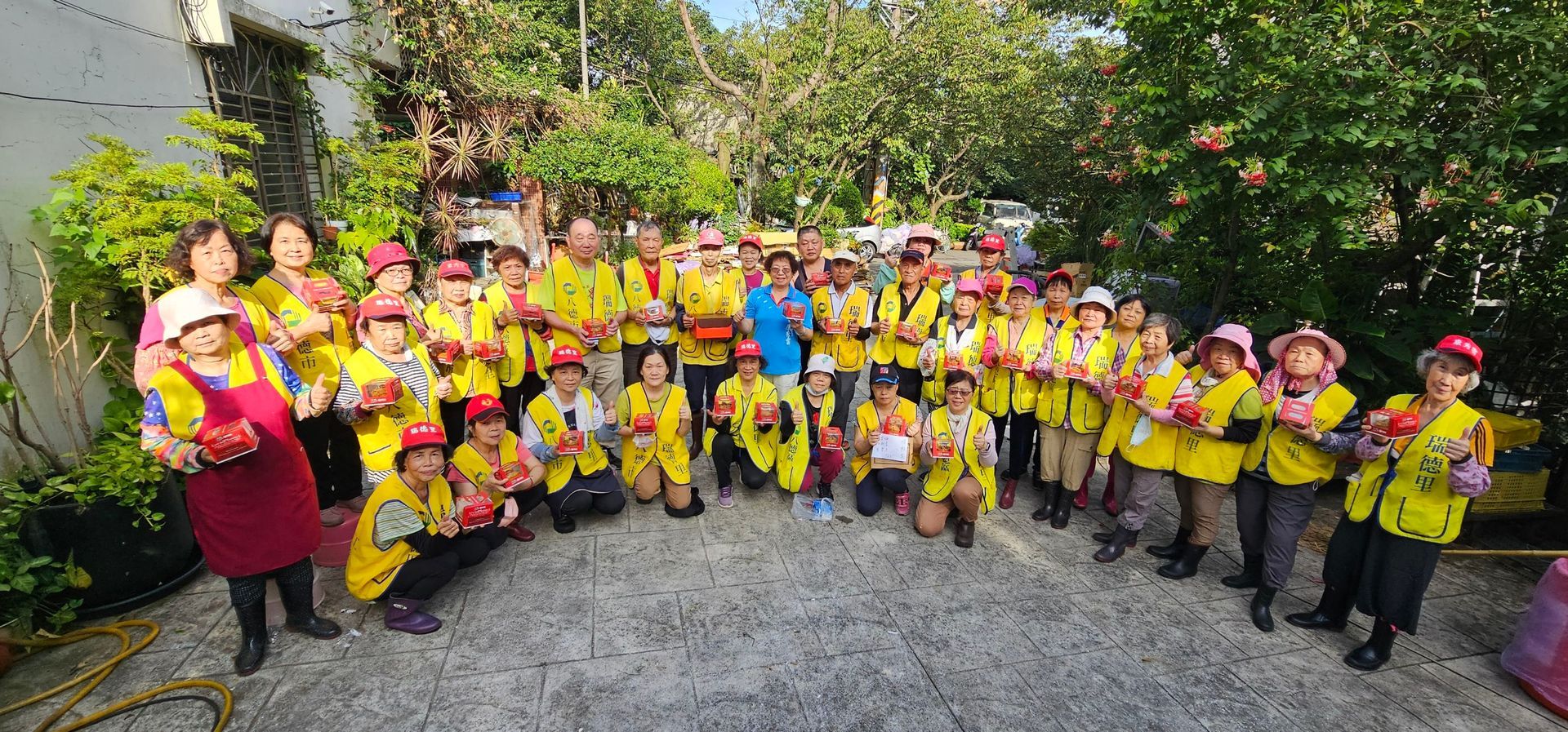 A group of people are posing for a picture in the woods.