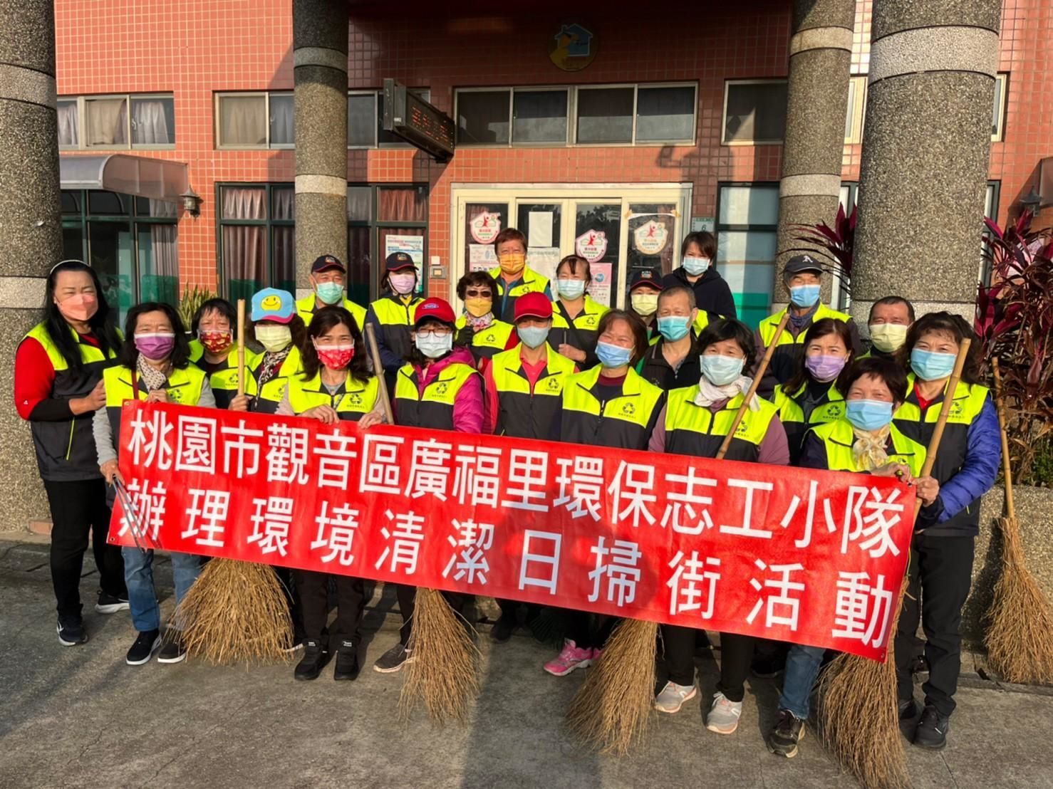 A group of people are posing for a picture with a banner that says ' taiwan ' on it.