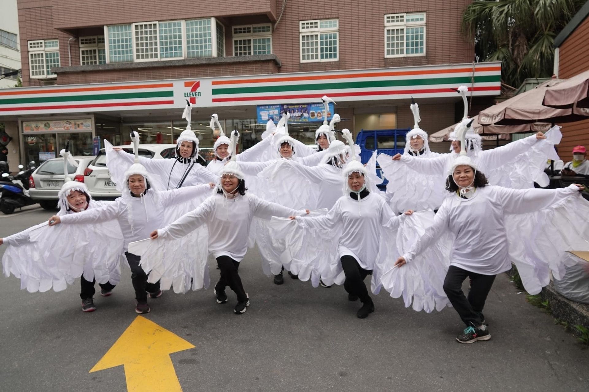 A group of people are posing for a picture in front of a mountain.
