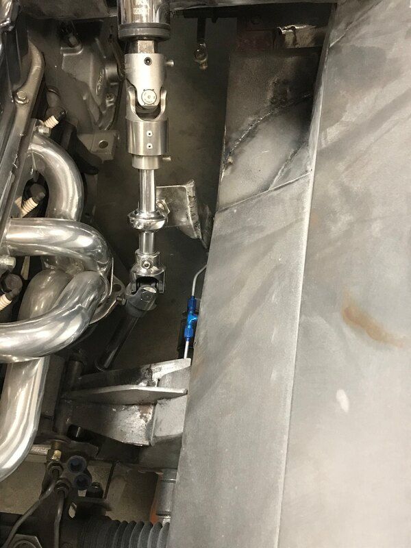 A close up of a steering shaft in a car.